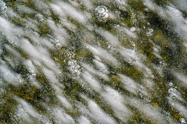 Texture pattern background white Winter, river ice air bubbles stagnant. drawing on ice frost formed. Severe cold frozen water. a large natural stream of water flowing in a channel to the sea, a lake