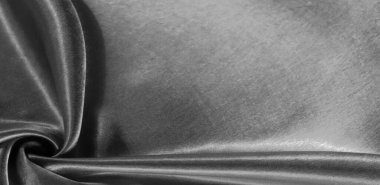 Doku, arkaplan, desen, siyah ipekten kumaş. Bu sevimli, yumuşak ve parlak kumaşın pürüzsüz bir vizon yüzeyi var. Projelerinizi yaratmak için mükemmel..
