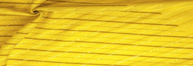 Tasarım arka plan dokusu, sarı kehribar rengi kumaş. Taze ve rahat bir stil için mükemmel..