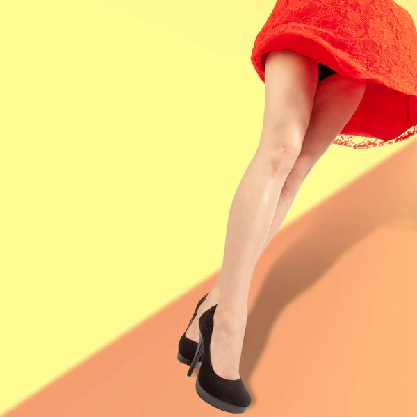 the girl\'s legs, the red dress raised by the wind, the wind, studio photography, the panties are visible from under the dress,