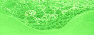 Doku, arkaplan, desen, kartpostal, ipek kumaş, dantel ambalajlı kadın bahar yeşil atkısı. Yazdırma ve dijital materyallerinizi oluşturmak için bu süslü resimleri kullanın.