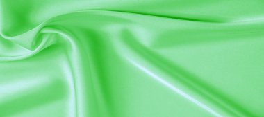 arka plan dokusu, desen. Yeşil zümrüt ipek kumaş. Bu, tasarım stilinize karmaşıklık katar. Yapısal stil özellikleri bazı kararlar, duvar kağıtları, posterler için harika.