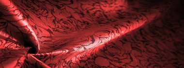 relief pattern, composite textiles, red silk fabric, with a floral pattern, unusually pleasant visual sensations: slippery, coolness, softness; beautiful appearance, unique luster;