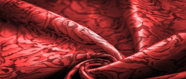 relief pattern, composite textiles, red silk fabric, with a floral pattern, unusually pleasant visual sensations: slippery, coolness, softness; beautiful appearance, unique luster;