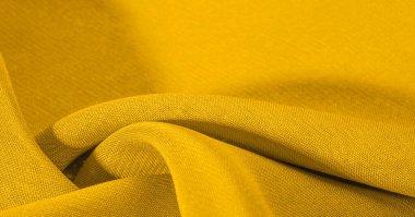 Arka plan dokusu, desen. Metalik pullu sarı kumaş. Bu güzel, hafif pullu kumaşın notaları, pullu aksanı ve güzel bir tasarımı var. Ayrıca güzel bir parıltısı var..