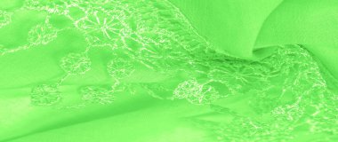 Doku, arkaplan, desen, kartpostal, ipek kumaş, dantel ambalajlı kadın bahar yeşil atkısı. Yazdırma ve dijital materyallerinizi oluşturmak için bu süslü resimleri kullanın.