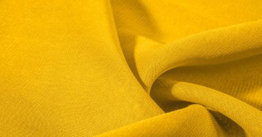Arka plan dokusu, desen. Metalik pullu sarı kumaş. Bu güzel, hafif pullu kumaşın notaları, pullu aksanı ve güzel bir tasarımı var. Ayrıca güzel bir parıltısı var..