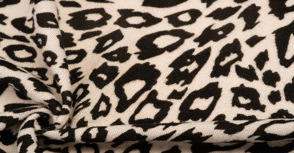 Texture, background, pattern, women\'s woolen shawl, black and beige, African motifs, shawl made of wool and modal with print in the form of a snake with a hem.
