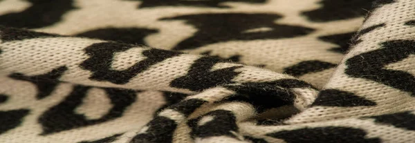 Texture, background, pattern, women\'s woolen shawl, black and beige, African motifs, shawl made of wool and modal with print in the form of a snake with a hem.