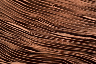 Doku, arkaplan, desen, kumaş kahverengi. Kayısı rengi. Gofre ve pileli. Tasarım projeleri lüks ve modaya uygun hale getiriyor. Bu kumaş köşeler, DIY projeleri vs. kullanılabilir.