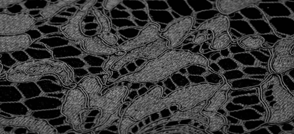 Texture, background, pattern, black lace fabric, delicate embossed lace fabric, scalloped on both edges. Suitable for your projects, design, etc.