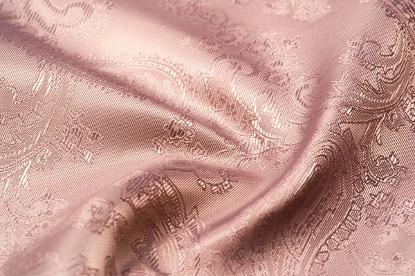 Texture, background, pattern. Fabric silk beige with a pattern of paisley. Precious Paisley Print, formatted in thick silk, is a simple and freely woven material for design,
