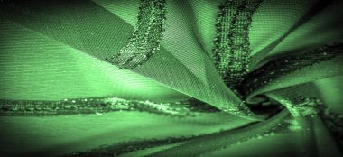 Doku arkaplan resmi. Kumaş şeffaf zümrüt yeşili. Parlak doğuştan gelen çizgileri var..