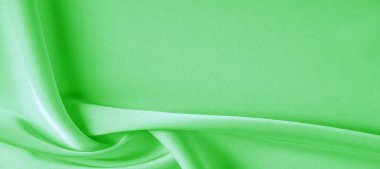 arka plan dokusu, desen. Yeşil zümrüt ipek kumaş. Bu, tasarım stilinize karmaşıklık katar. Yapısal stil özellikleri bazı kararlar, duvar kağıtları, posterler için harika.