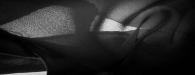 Doku, arkaplan, desen, saten siyah genellikle parlak bir yüzeye ve donuk bir sırta sahip, saten dokuma dört ya da daha fazla dolgu ipliği ile karakterize edilir.,