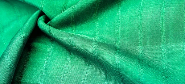 Texture, background, pattern, simple green fabric with lines. The lines formed by the extraction of the thread,