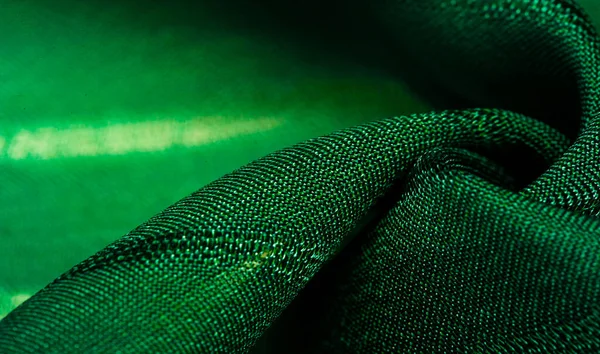 Texture, background, pattern, simple green fabric with lines. The lines formed by the extraction of the thread,