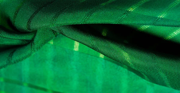 Texture, background, pattern, simple green fabric with lines. The lines formed by the extraction of the thread,