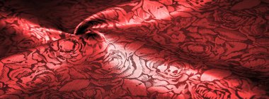 relief pattern, composite textiles, red silk fabric, with a floral pattern, unusually pleasant visual sensations: slippery, coolness, softness; beautiful appearance, unique luster;