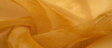 Arka plan dokusu, desen. Metalik pullu sarı kumaş. Bu güzel, hafif pullu kumaşın notaları, pullu aksanı ve güzel bir tasarımı var. Ayrıca güzel bir parıltısı var..