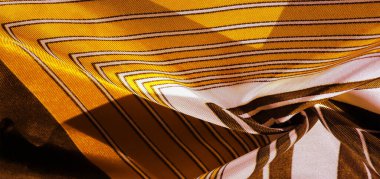 Doku, arkaplan, sarı çizgili ipek kumaş. Bu kumaşın tasarımı muhteşem bir yeleğin görünümünü temsil eden beyaz tavşan mozaiğine adanmıştır..