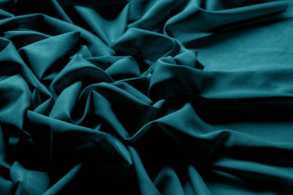 Textured, background, pattern, turquoise fabric. This is an unusual fabric that has an elegant appearance with a rich and coarse texture. It is tightly knit with designs built into the fabric itself