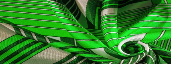 Texture,  silk fabric with a green striped pattern. The design of this fabric is devoted to a patchwork mosaic in the style of a white rabbit, representing what a fairytale\'s vest might look like.
