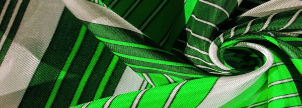 Texture,  silk fabric with a green striped pattern. The design of this fabric is devoted to a patchwork mosaic in the style of a white rabbit, representing what a fairytale\'s vest might look like.