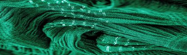 Arka plan resminin dokusu suyun altındaki kumaşın rengi, yeşil-mavi kıvrımlı kumaş, paralel veya çapraz kıvrımlı, tırtıklı katlı kumaş; böyle bir kumaştan çıkan ürünler..