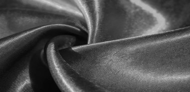 Doku, arkaplan, desen, siyah ipekten kumaş. Bu sevimli, yumuşak ve parlak kumaşın pürüzsüz bir vizon yüzeyi var. Projelerinizi yaratmak için mükemmel..