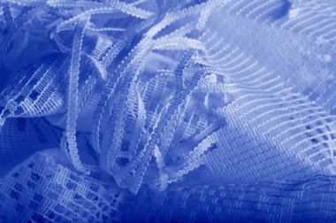 Doku, arka plan mavi tül. Bu olağanüstü naylon tülü kullanarak bir aksesuara hacim, yetenek ya da detaylı tasarım ayrıntıları ekleyin! Yumuşak tül tasarım gereksinimlerinizi karşılıyorsa, diğer kalıplara bakın