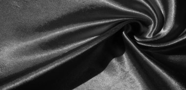 Doku, arkaplan, desen, siyah ipekten kumaş. Bu sevimli, yumuşak ve parlak kumaşın pürüzsüz bir vizon yüzeyi var. Projelerinizi yaratmak için mükemmel..