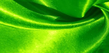 Doku, arkaplan, desen, yeşil renkli ipek kumaş. Bu sevimli, yumuşak ve parlak kumaşın pürüzsüz bir vizon yüzeyi var. Projelerinizi yaratmak için mükemmel..