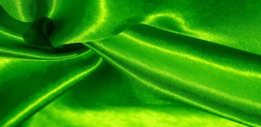 Doku, arkaplan, desen, yeşil renkli ipek kumaş. Bu sevimli, yumuşak ve parlak kumaşın pürüzsüz bir vizon yüzeyi var. Projelerinizi yaratmak için mükemmel..