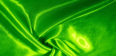 Doku, arkaplan, desen, yeşil renkli ipek kumaş. Bu sevimli, yumuşak ve parlak kumaşın pürüzsüz bir vizon yüzeyi var. Projelerinizi yaratmak için mükemmel..