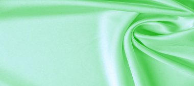 arka plan dokusu, desen. Yeşil zümrüt ipek kumaş. Bu, tasarım stilinize karmaşıklık katar. Yapısal stil özellikleri bazı kararlar, duvar kağıtları, posterler için harika.