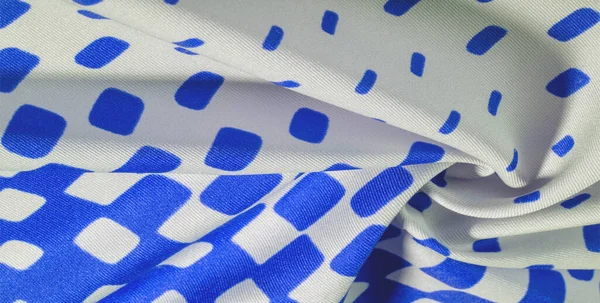 texture background pattern. silk fabric with a pattern of blue squares on a white background. This is a heavy square 100% polyester pattern that fits perfectly with modern, transitional or contemporary design.