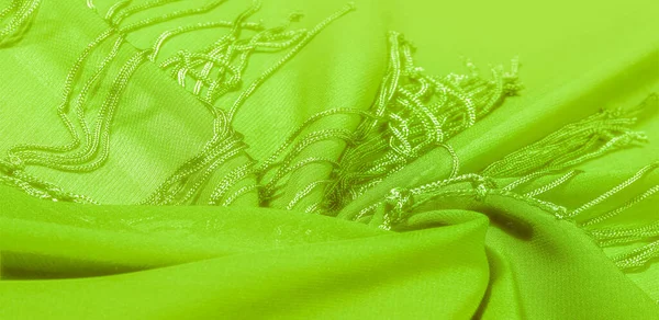 Background texture of silk fabric. This is a natural green salad scarf, this beautiful nylon satin made of artificial silk with a transparent hand and a wonderful sheen is perfect for your projects.