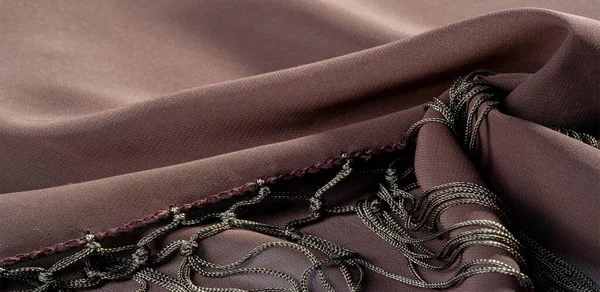 Background texture of silk fabric. This is a natural brown scarf, this beautiful nylon satin made of artificial silk with a clear hand and a wonderful sheen is perfect for your projects.