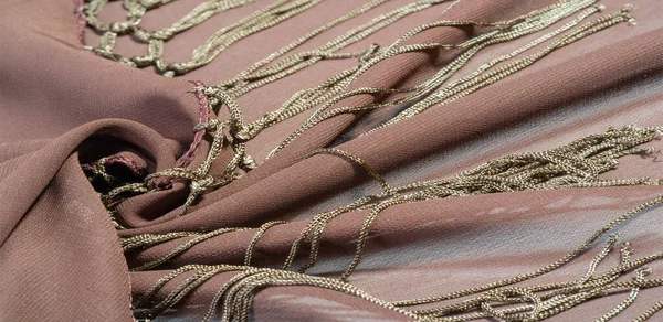 Background texture of silk fabric. This is a natural brown scarf, this beautiful nylon satin made of artificial silk with a clear hand and a wonderful sheen is perfect for your projects.