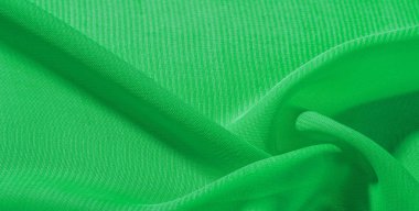 doku arka plan desen yeşil ipek kumaş. Bu ipek organze nazik bir açık diş vardır. Bu lüks kumaşı, özel günler için tasarımınızdan projelerinizi oluşturmaya kadar her şey için kullanın.