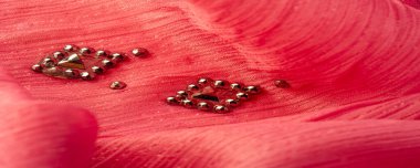 Arkaplan tasarımı dokusu, ipek desen, pembe kumaş ve dekoratif işlemeli taşlar.