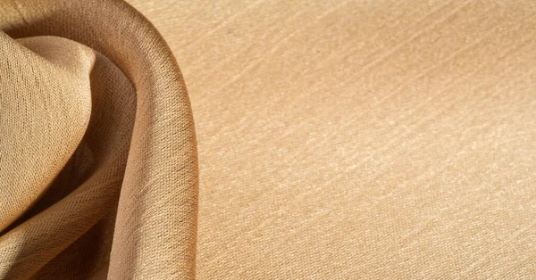 Background, pattern, texture, beige golden silk fabric It has a smooth matte finish and is durable due to a slightly twisted yarn. Use this luxurious fabric for anything - from design to your projects