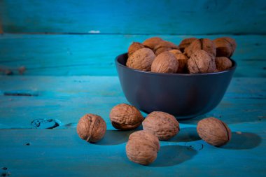 Ceviz çekirdekleri ve tüm cevizleri mavi bir levhada.