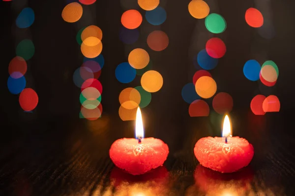 Valentines Day, a romantic still life of burning candles from hearts laid out on a blurred background, bokeh effect, shallow depth of field. Beautiful holiday picture. — ストック写真