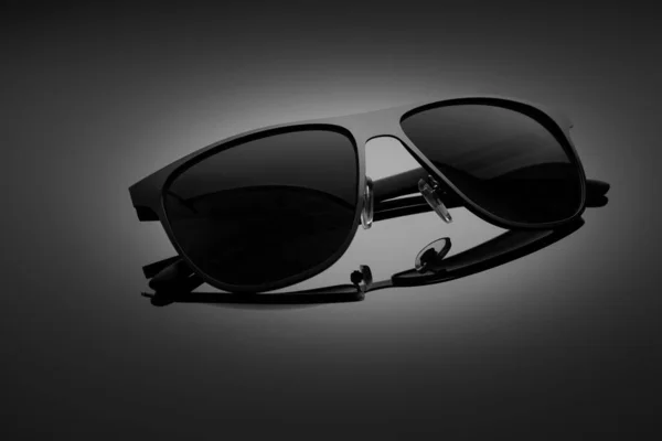 Sunglasses on a black gradient, matte background, shallow depth of field. The concept is stylish and beautiful. — 스톡 사진