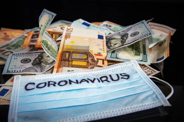 Coronavirus inscription on a medical mask on top of world international banknotes. US dollars and euros. Coronavirus Warning. — 图库照片