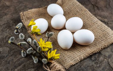 Taze organik çiftlik yumurtaları çuval bezi üzerinde, taş bir levhanın üzerinde, yakın plan, seçici odaklanma, sığ alan derinliği. Kavram, sağlıklı yiyecek, bahar dini bayramı.