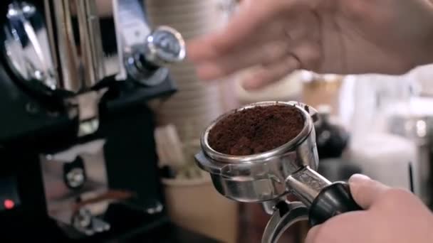 Making Ground Coffee with Tamping fresh coffee.Coffee grinder grinds coffee beans into a filter holder