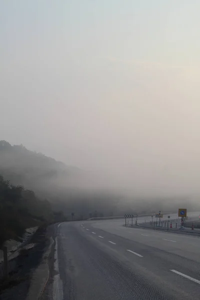 Mountain landscape in the fog. house in the mountains. The old spooky house on the land of nowhere. Wooden house in the middle of the barren land. Scenic retro landscape.